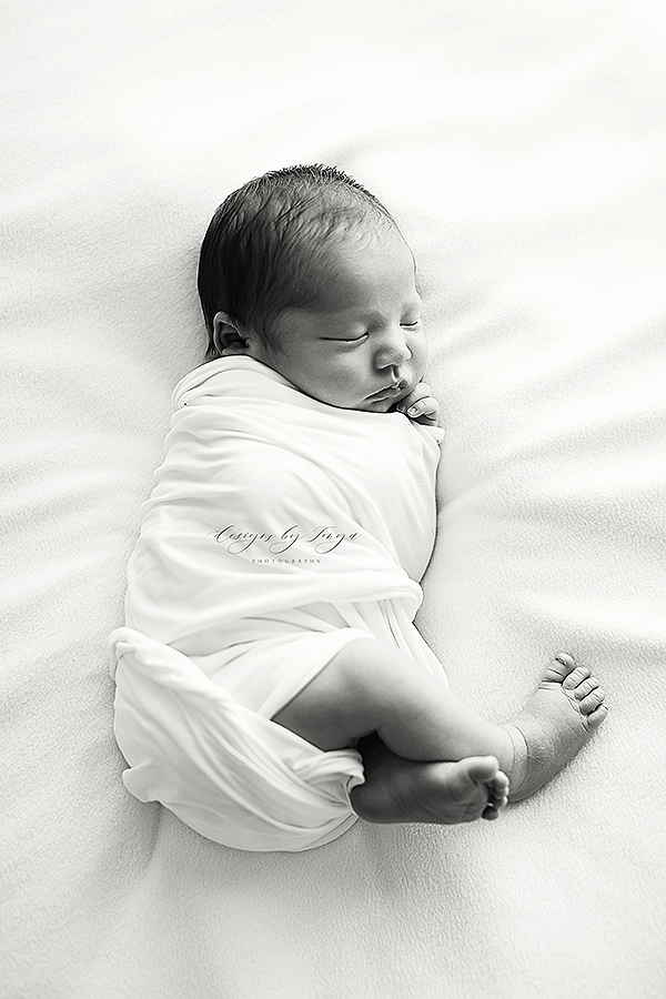 Fresno-Newborn-Photographer-Designs-By-Tonya-Photography Swaddled Newborn Boy On White Blanket